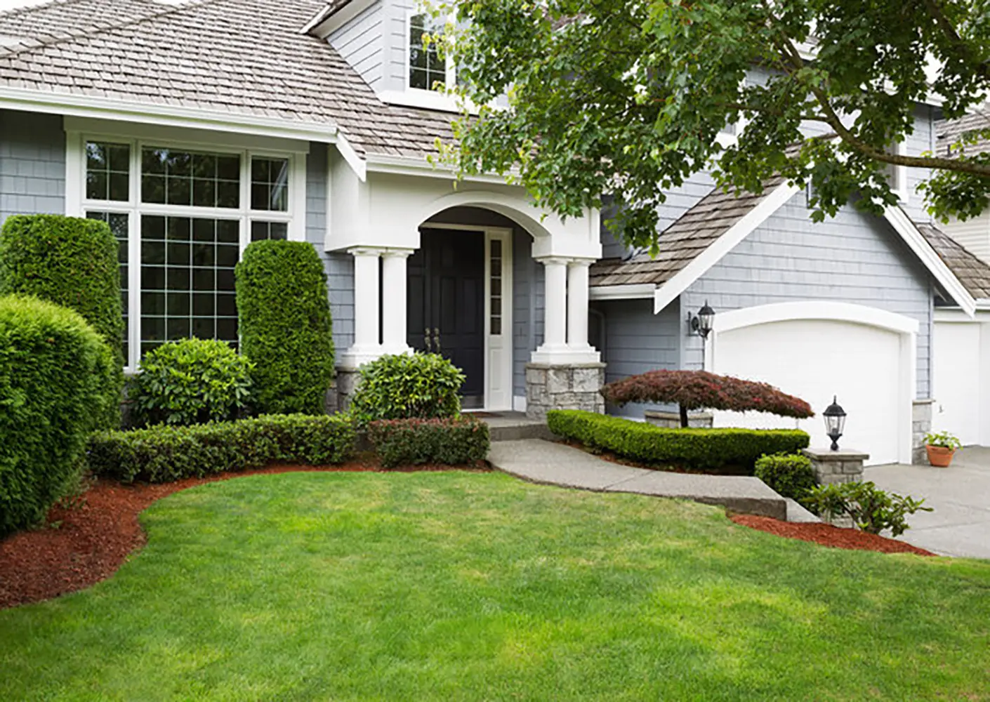 Gray painted home exterior under natural light illustrating how sun exposure affects exterior paint color