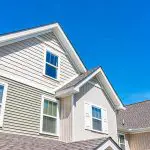 Exterior view of a home with painted siding and trim showing what causes paint to peel on exterior walls over time