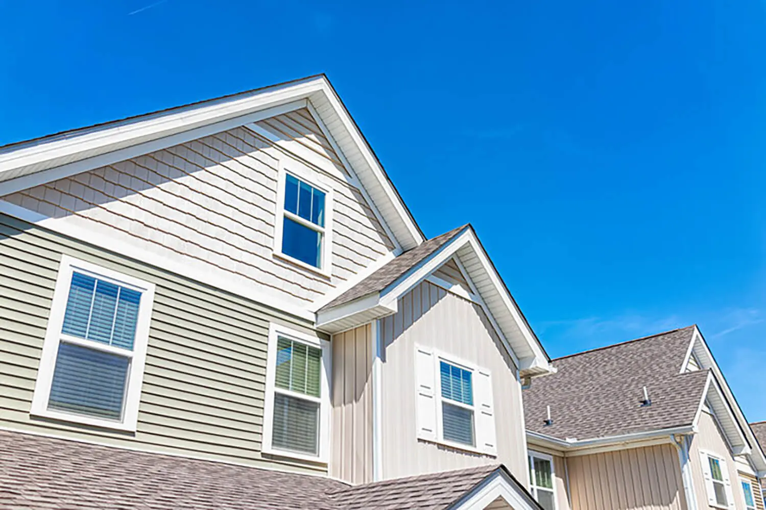 Exterior view of a home with painted siding and trim showing what causes paint to peel on exterior walls over time