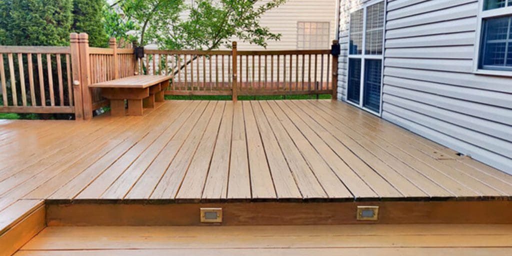 Stained wood deck with railing and built-in bench in a Northern Virginia backyard